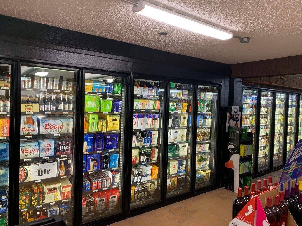 Liquor store design featuring a large beer and can cooler with multiple display doors.