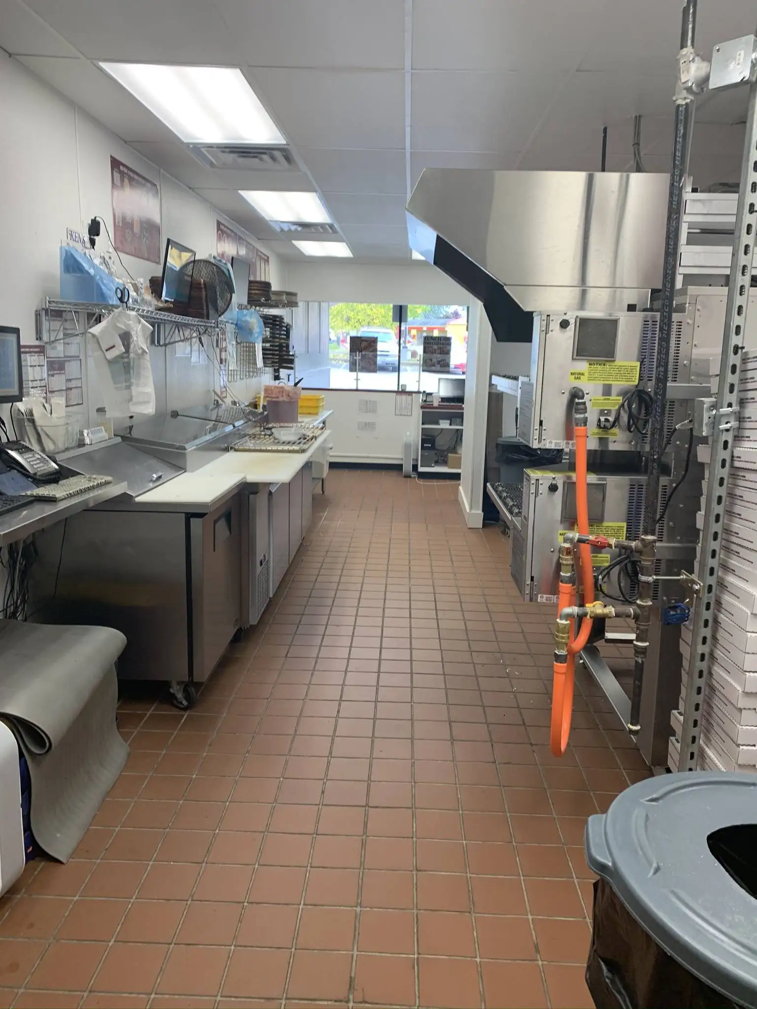 Commercial kitchen construction with stainless steel appliances and ventilation hoods